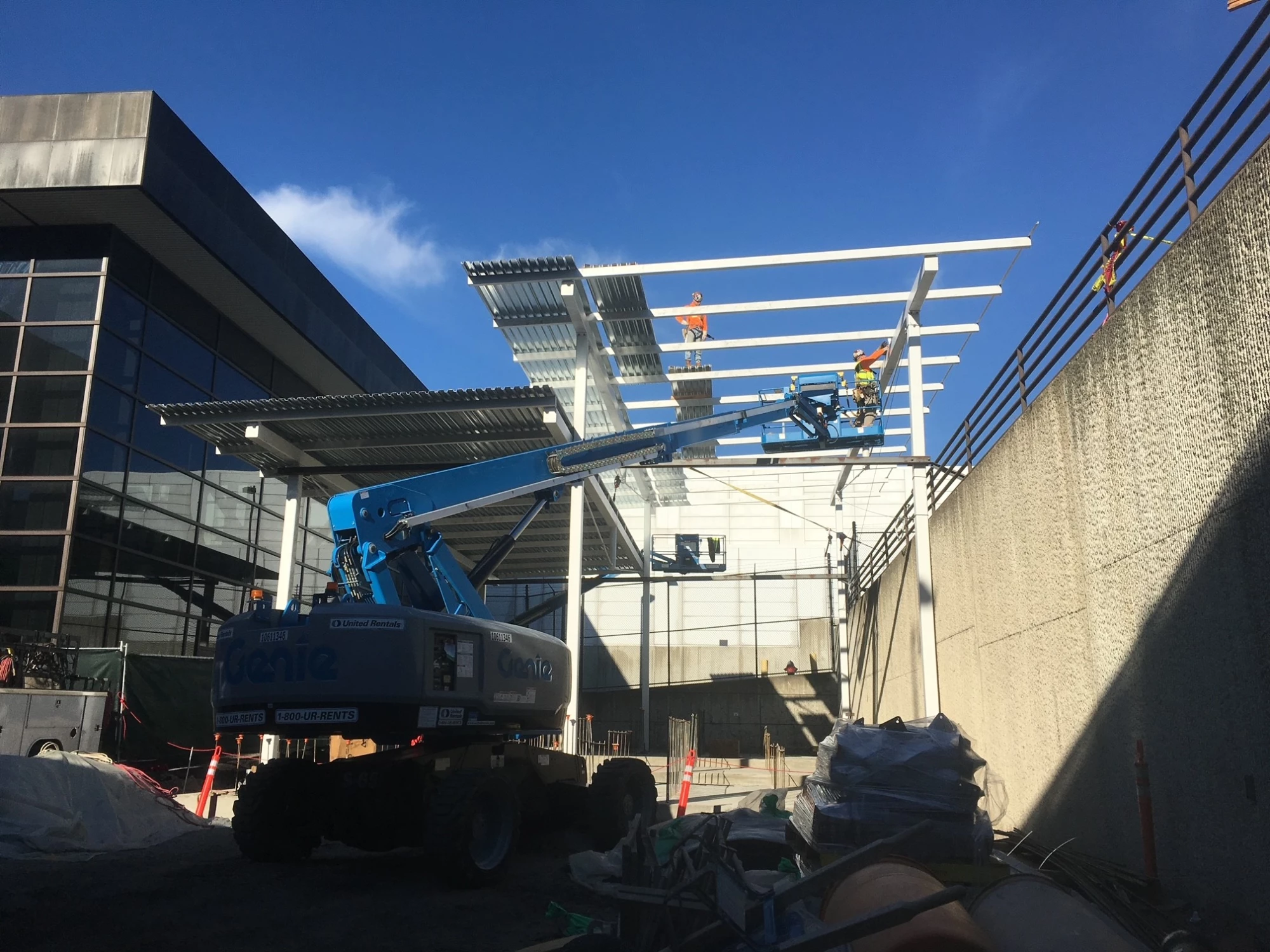 Iron worker aloft setting steel girders